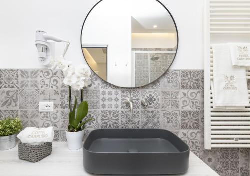 a bathroom with a black sink and a mirror at Coppa Carrubo Residenza in Vieste