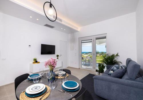 a living room with a table and a couch at Coppa Carrubo Residenza in Vieste