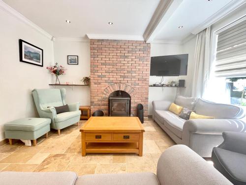 a living room with a couch and a fireplace at Clyde Villa in Glasgow