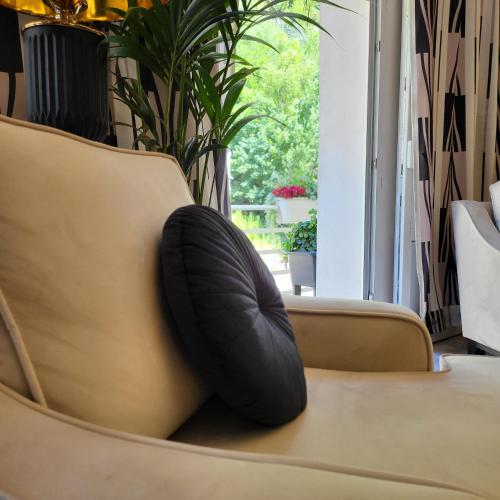 a black pillow sitting on top of a couch at Apartment Villa Hřensko 132 in Hřensko