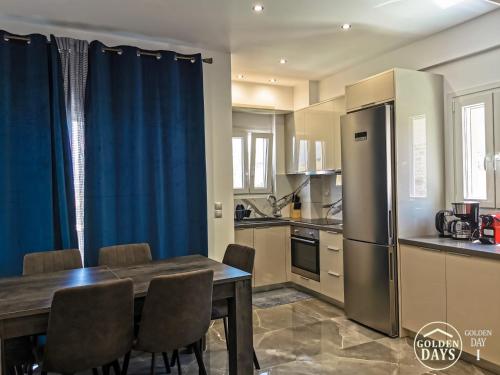 a kitchen with a dining table and a refrigerator at Golden Days villas in Sívas