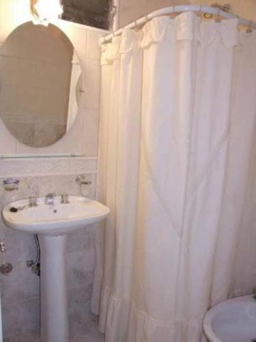 a bathroom with a sink and a shower curtain at Locaciones Colón in Colón