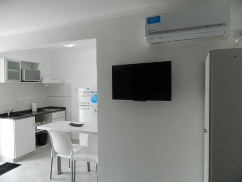 a flat screen tv hanging on a wall in a kitchen at Locaciones Colón in Colón