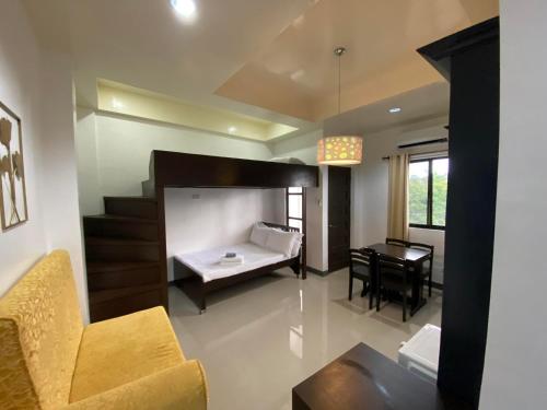 a room with a bed and a table and a desk at Ma Lourdes' Inn in Palompon