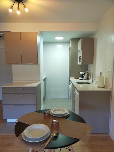 a kitchen with a table with two plates on it at Apartamento Sofía in Llanes