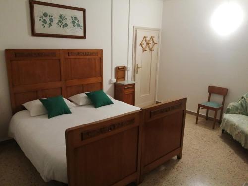 a bedroom with a large bed and a chair at Il Sogno in Foligno