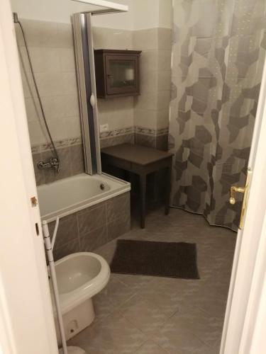 a bathroom with a toilet and a tub and a sink at Il Sogno in Foligno