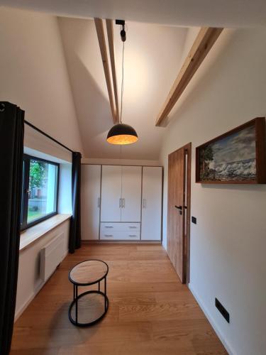 a hallway with a round table and a ceiling at E29 in Plateliai