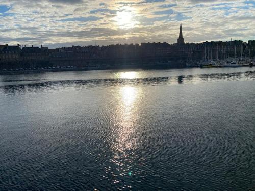 a large body of water with a city in the background at la merveille de Rochebonne 3 in Saint Malo