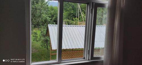 an open window with a view of a roof at Qabala Villa House Samir in Gabala