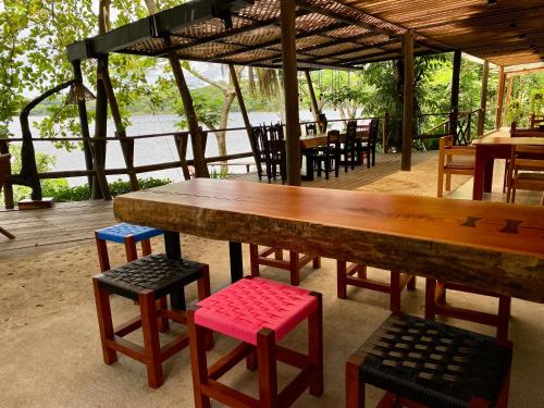 a large wooden table and some chairs and tables at Villa Maya in Flores