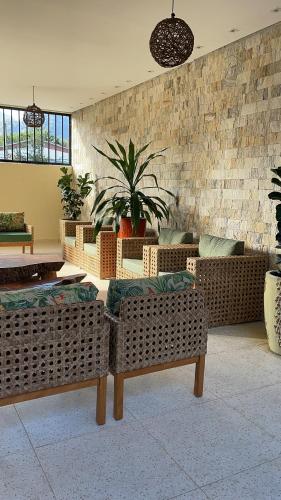 a living room with couches and potted plants at Pousada Ilha Vitoria in Ubatuba
