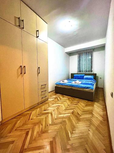 a bedroom with a bed and a wooden floor at DARTAD APARTMENT in Ohrid