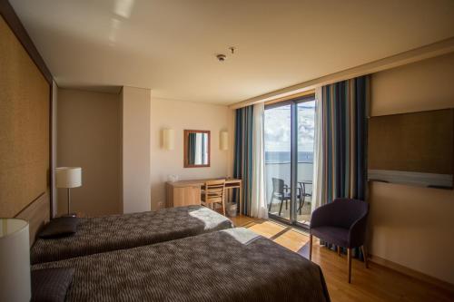 Llit o llits en una habitació de Antillia Hotel