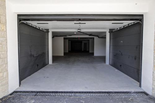 an empty parking lot with two garage doors at Allure Apartments in Ulcinj