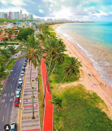 an aerial view of a beach with palm trees at Mardisa Design by Jess Hospedagens in João Pessoa