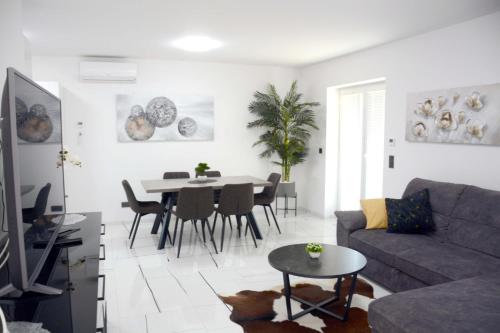 a living room with a couch and a table at Apartmani Magić in Jalžabet