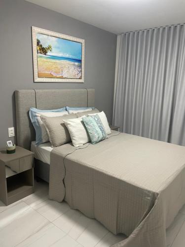 a bedroom with a bed and a painting on the wall at Mardisa Design by Jess Hospedagens in João Pessoa