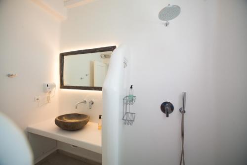 a bathroom with a wooden sink and a mirror at Villa Meliti in Platis Gialos