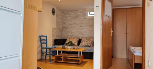 a living room with a couch and a table at apartman Lucija in Punat