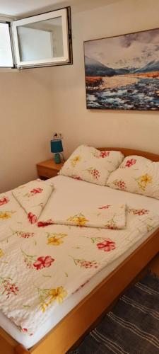 a bedroom with two beds with flowers on the sheets at apartman Lucija in Punat