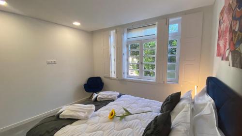 a bedroom with a bed with a flower on it at FERREIRA'S HOUSE Guimarães in Guimarães
