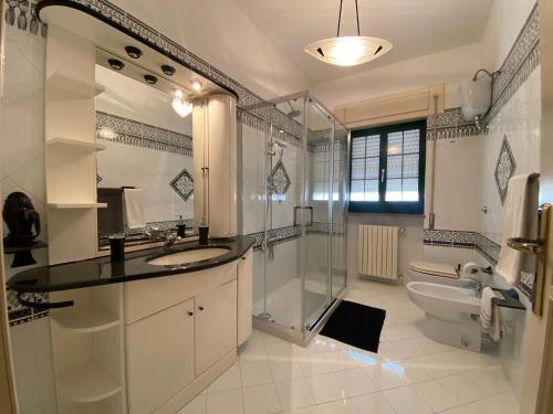 a bathroom with a shower and a sink and a toilet at La Campanella in Manduria