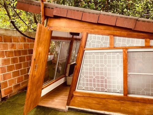a window in a house with a brick wall at VILLA CRISTAL in Santa Helena