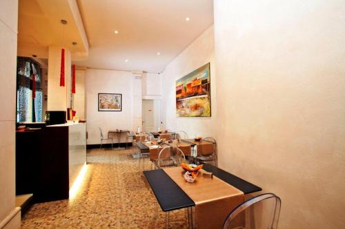 a living room with a table and a dining room at Momi's Hotel in Cavarzere
