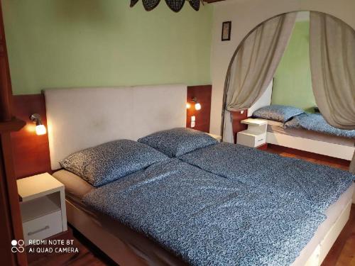 a bedroom with a large bed and a mirror at Penzion u Lípy in Děčín