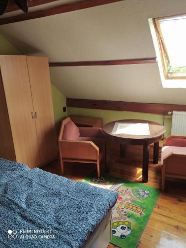 a room with a table and a bed and a table at Penzion u Lípy in Děčín