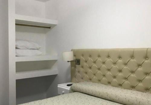 a bedroom with a bed with a beige headboard at BY DANIELS in Federación