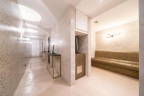 a bathroom with a walk in shower and a large mirror at Hotel Millennium by Aycon in Budva