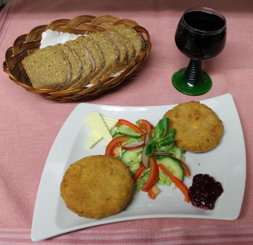 a plate of food with a basket of bread and vegetables at Hotel Schäfflerhof in Bischofsmais