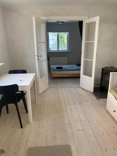a room with a desk and a bedroom with a bed at Annex near beach close to Copenhagen in Vedbæk