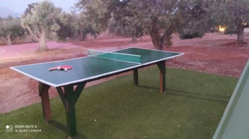 a ping pong table in the middle of a field at Villa in the Olive Trees in Galaxidhion