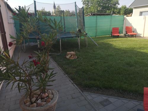 a yard with a chair and a swing at Levendula Apartman in Makó