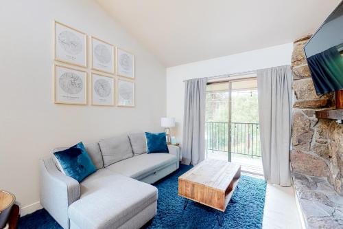 a living room with a couch and a fireplace at Rustic Relaxation in Winter Park in Winter Park