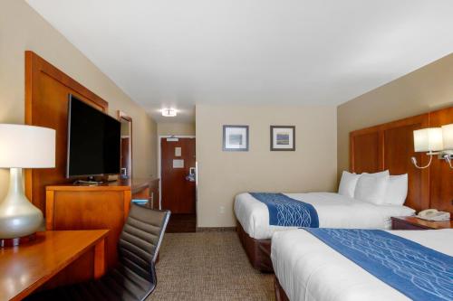 a hotel room with two beds and a flat screen tv at Comfort Inn & Suites Woods Cross - Salt Lake City North in Woods Cross