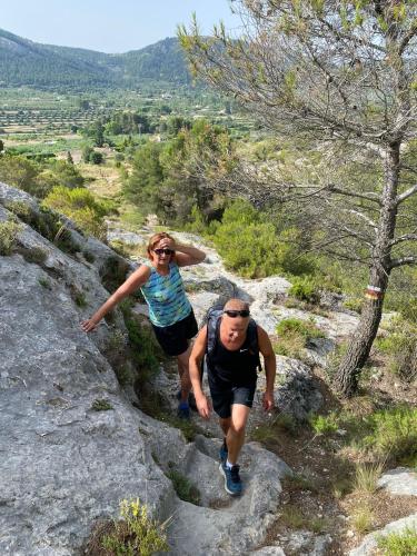 a man and a woman walking down a rocky trail at B&B Finca la Yuca "Un paraíso en Ontinyent" in Ontinyent