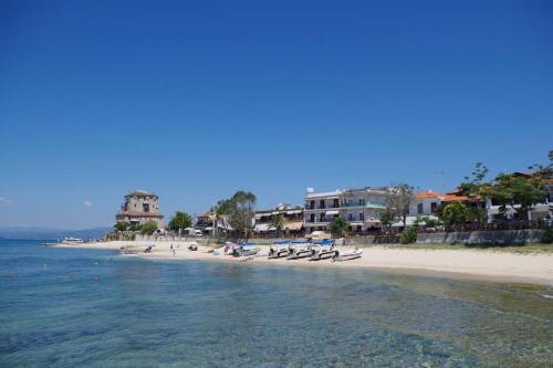 a beach with a group of boats in the water at Seafront Centre Ouranoupoli in Ouranoupoli