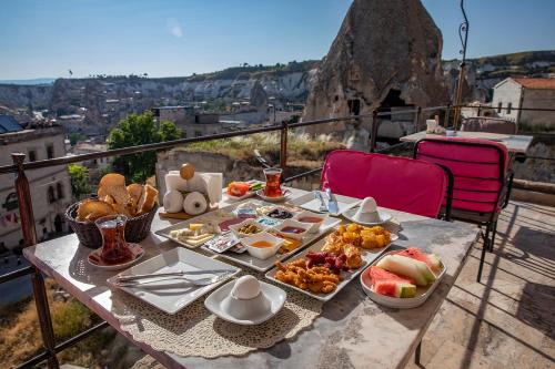 a table with a tray of food on a balcony at Charming Cave Hotel in Goreme