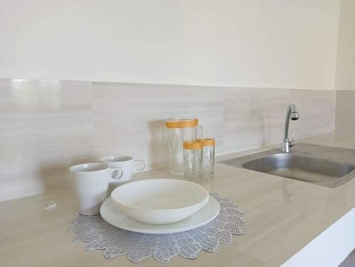A kitchen or kitchenette at Reinhardshausen Suites and Residences - Cozy Air-conditioned Units