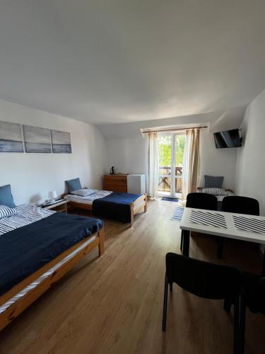 a large room with two beds and a window at Dom Wypoczynkowy Sztorm in Ostrowo