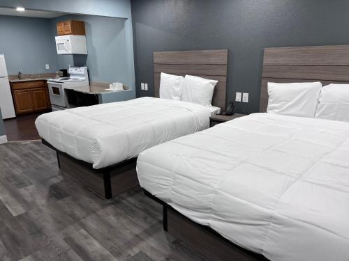 a hotel room with two beds and a kitchen at Surf City Inn & Suites in Santa Cruz