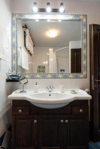 a bathroom with a sink and a large mirror at Sifnos' Green and Blue in Sifnos