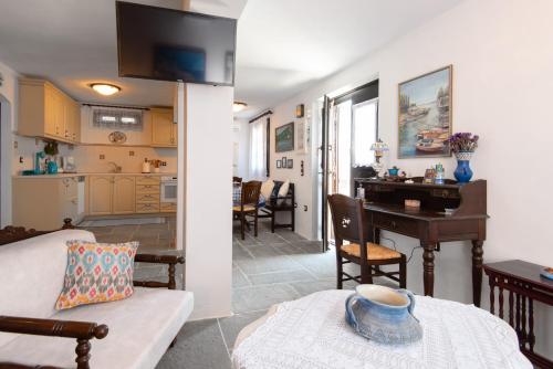 a living room and a kitchen with a table at Sifnos' Green and Blue in Sifnos