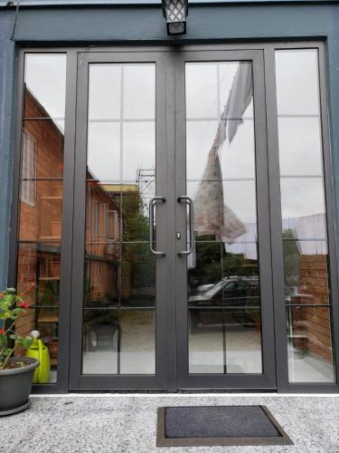 a glass door with a view of a patio at MIDIA Guest House in K'obulet'i