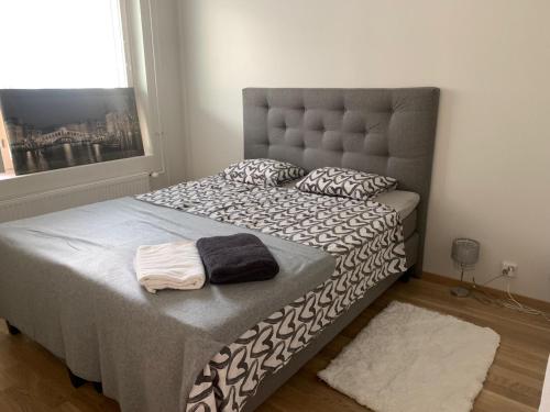a bedroom with a bed with two towels on it at Modern one bedroom apartment nearby Airport in Vantaa