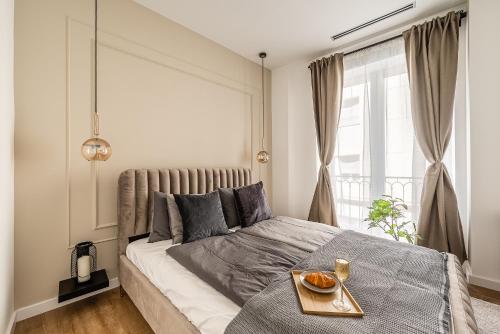 a bedroom with a bed with a tray of oranges on it at Asboth Boutique Budapest in Budapest